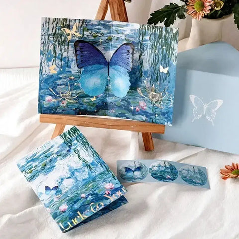3D butterfly pop-up greeting card displayed on easel with floral design and matching envelope.